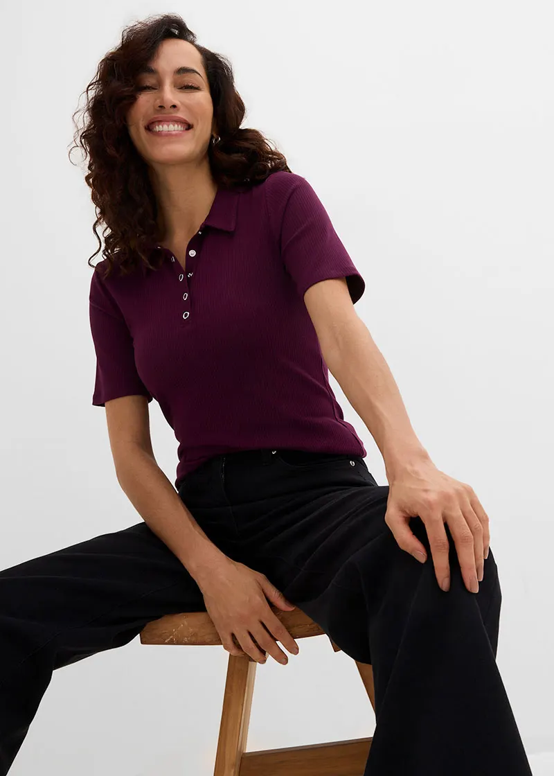 Burgundy polo shirt and wide black trousers